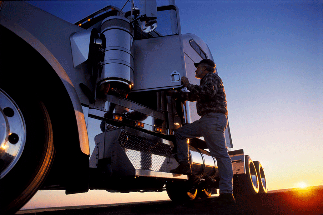 a-silhouette-of-a-truck-driver-getting-into-the-ca-EA5HK98